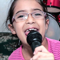 Image of young person singing in microphone